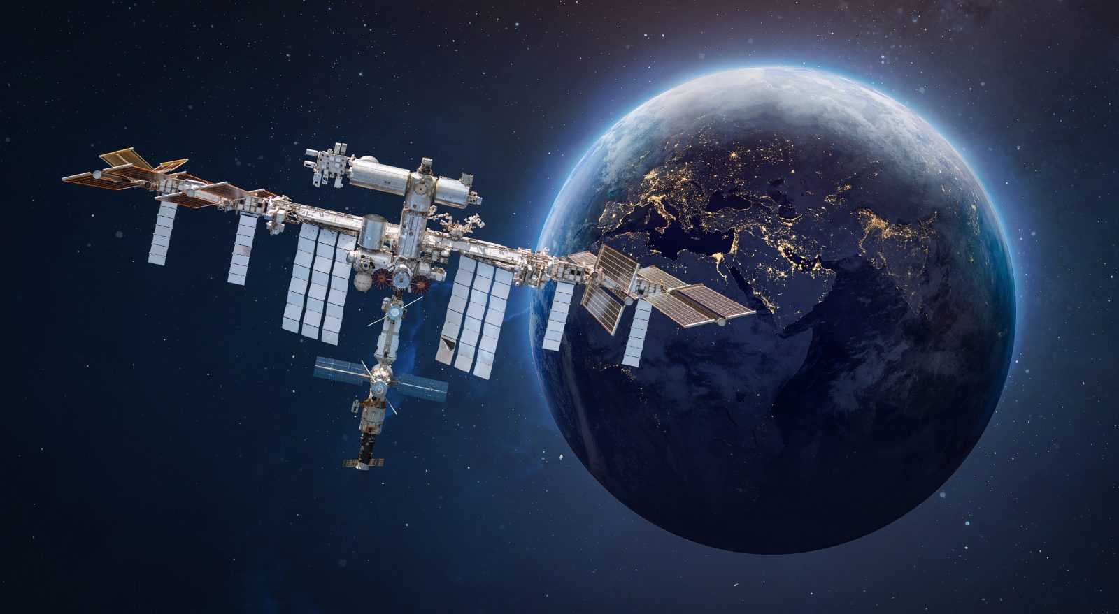 International space station in outer space. ISS on orbit of Earth planet. Space sci-fi collage with satellite and spaceship. Astronauts on orbit. Elements of this image furnished by NASA