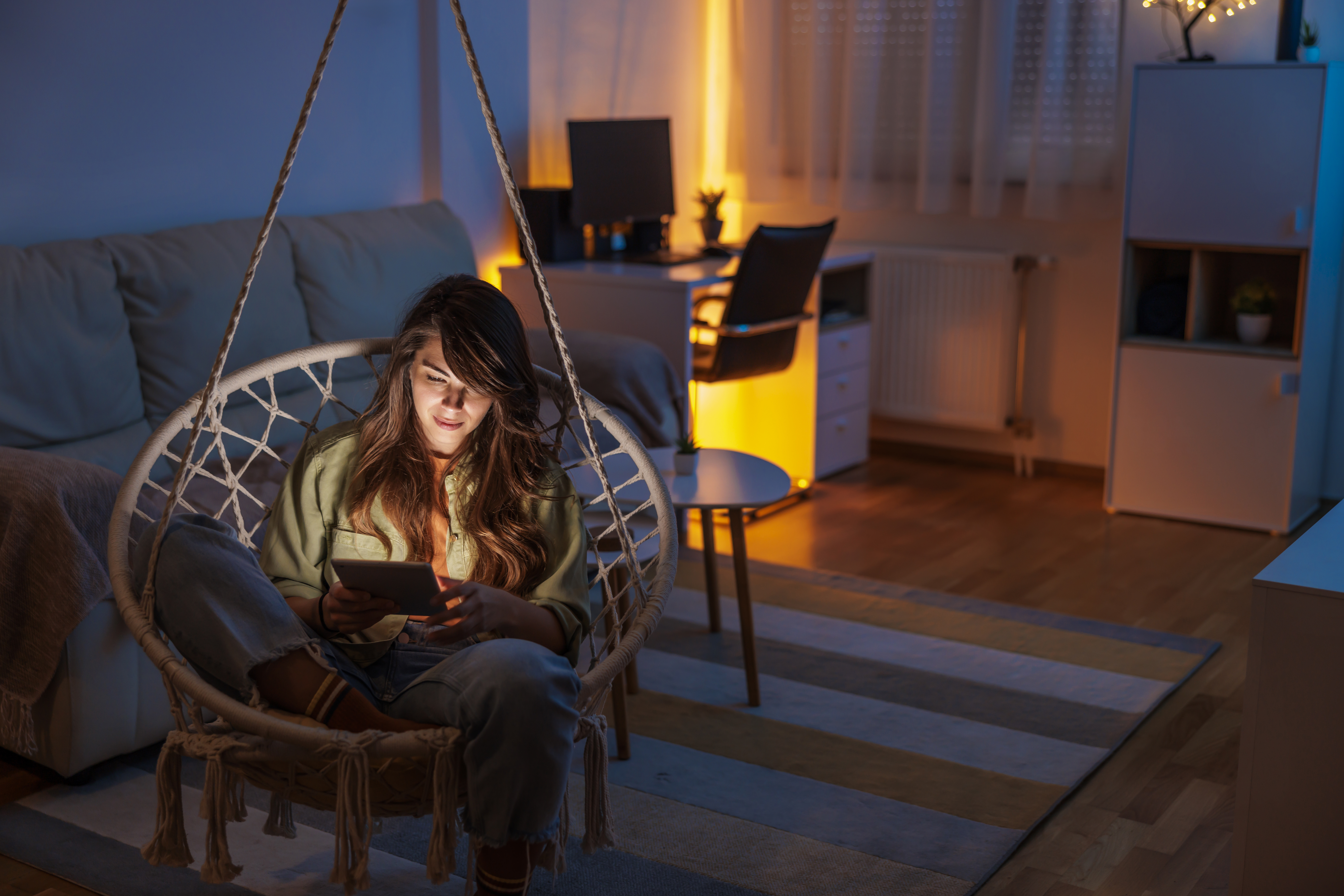 Woman relaxing at home reading an ebook